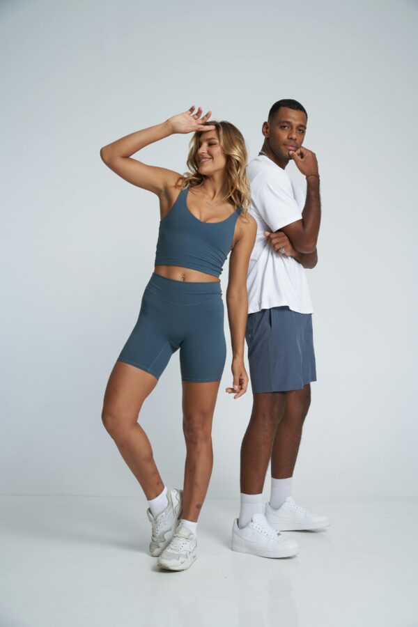 Woman and Man Posing in Gym Clothing