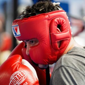 Boxer in Head Guard and Gloves